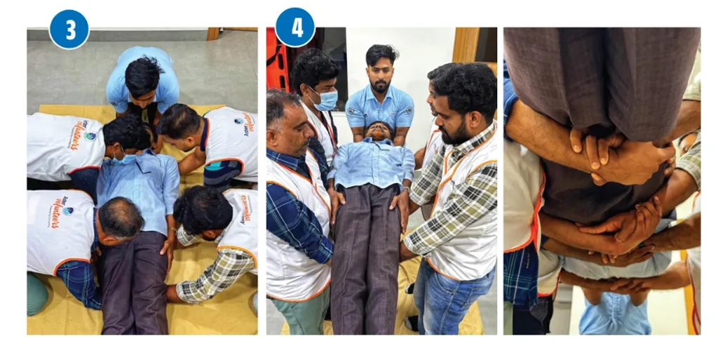 നാലുപേരും കൈകൾ കോർത്ത് കൈത്തണ്ടയിൽ താങ്ങി പരിക്കേറ്റയാളെ ആംബുലൻസിലേക്ക് നീക്കുക.